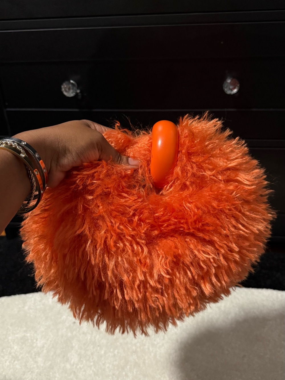 Fuzzy orange handbag with round handle